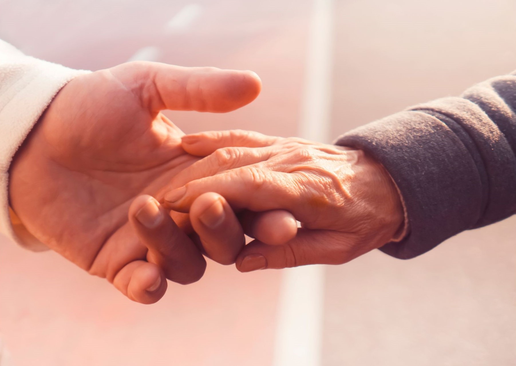 Man holding womans hand in support