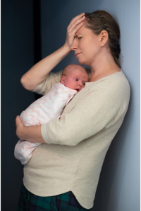 Mother holding her baby while receiving support during postpartum recovery